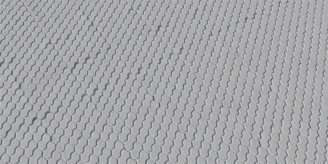 Patterned concrete pavers with a stamped surface texture