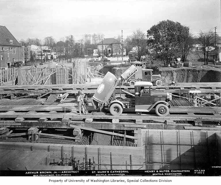 Historic photograph of trucks pouring concrete at a cathedral foundation
