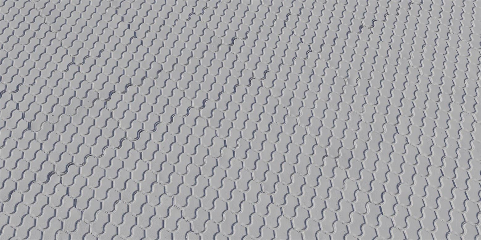 Patterned concrete pavers with a stamped surface texture